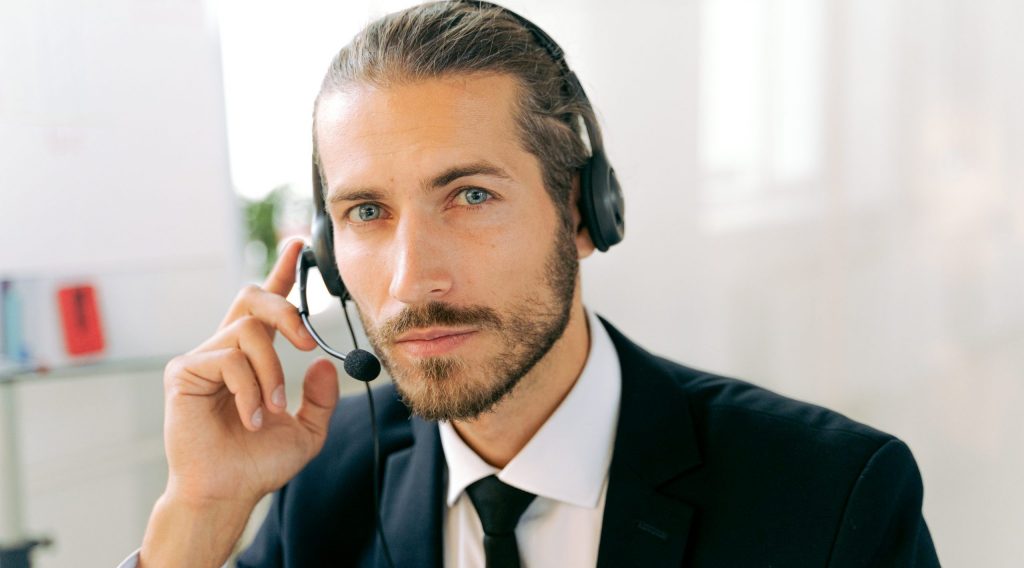 Man in black suit holding smartphone