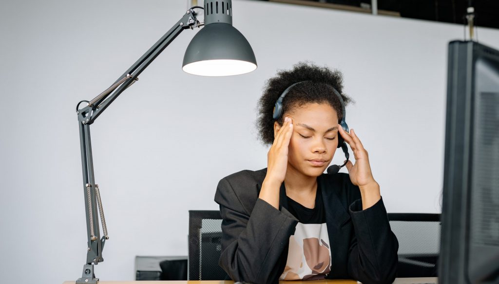 A tired woman massaging her head