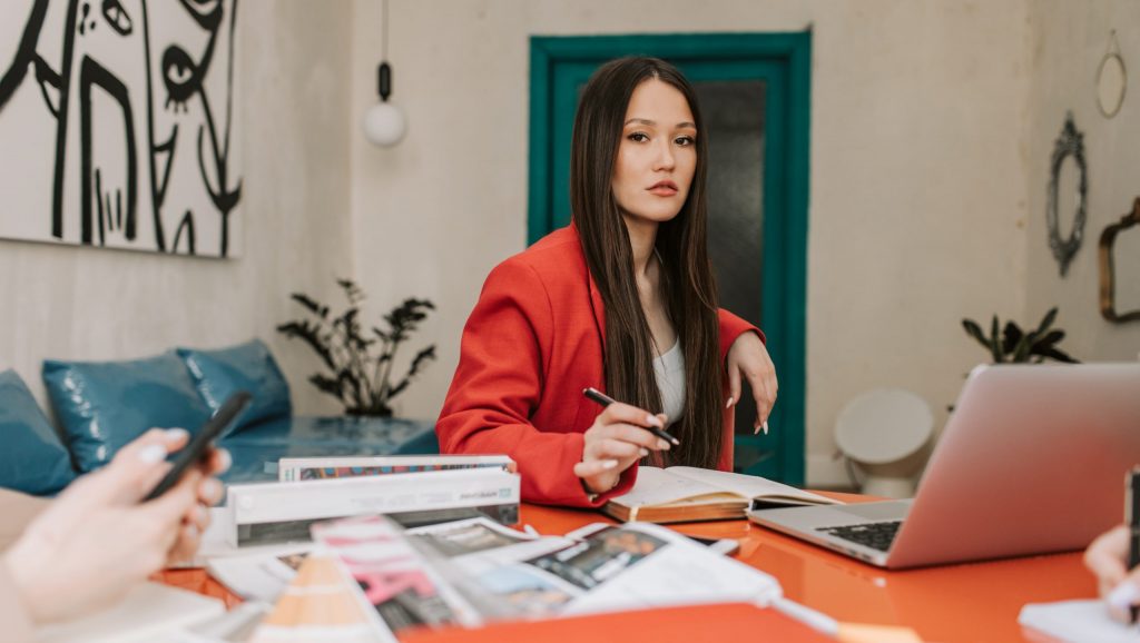 A woman in red blazer working in the office