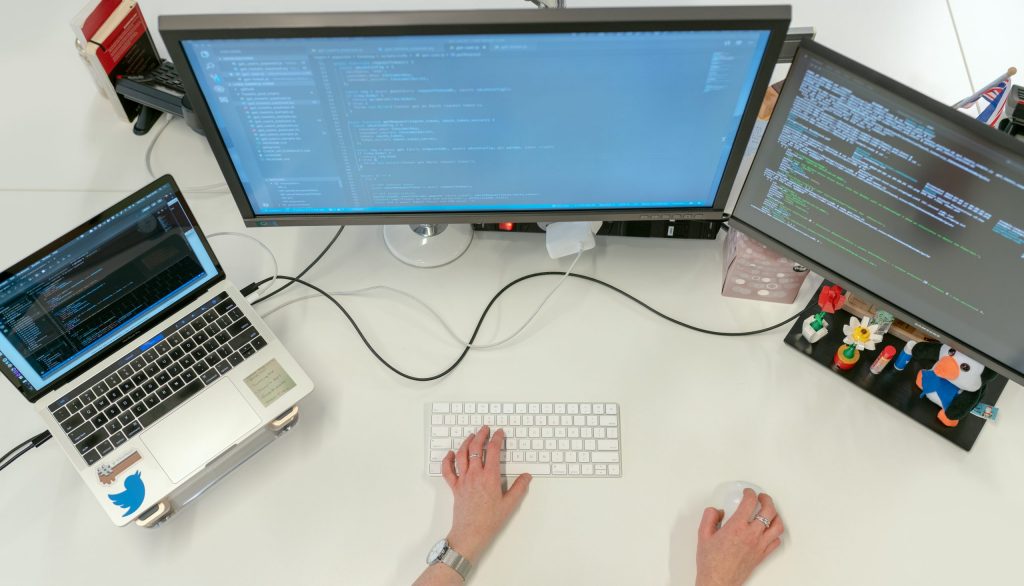 Female software engineer coding on computer