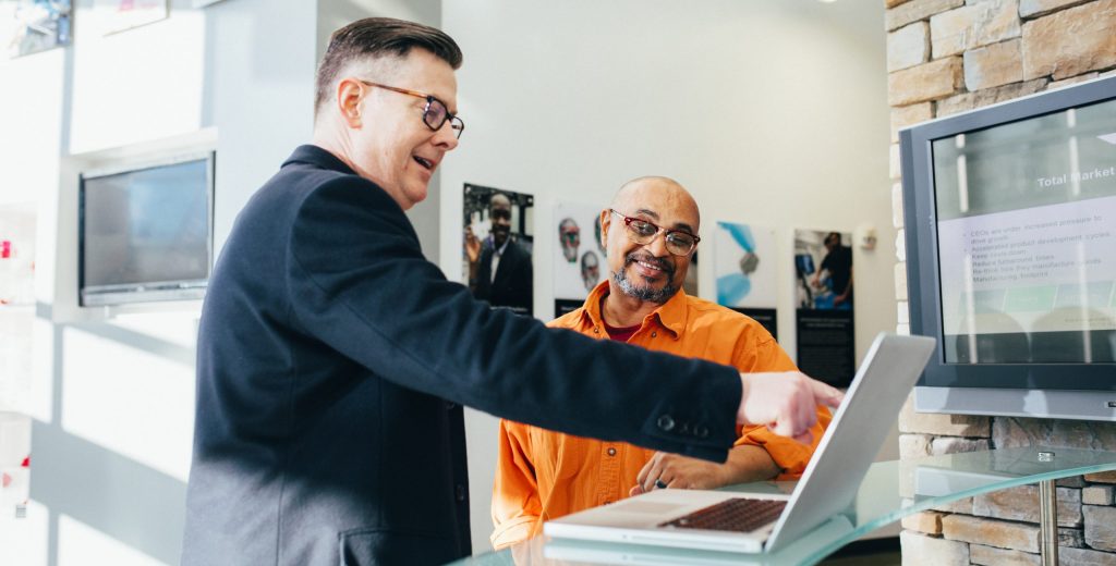 Man pointing laptop computer