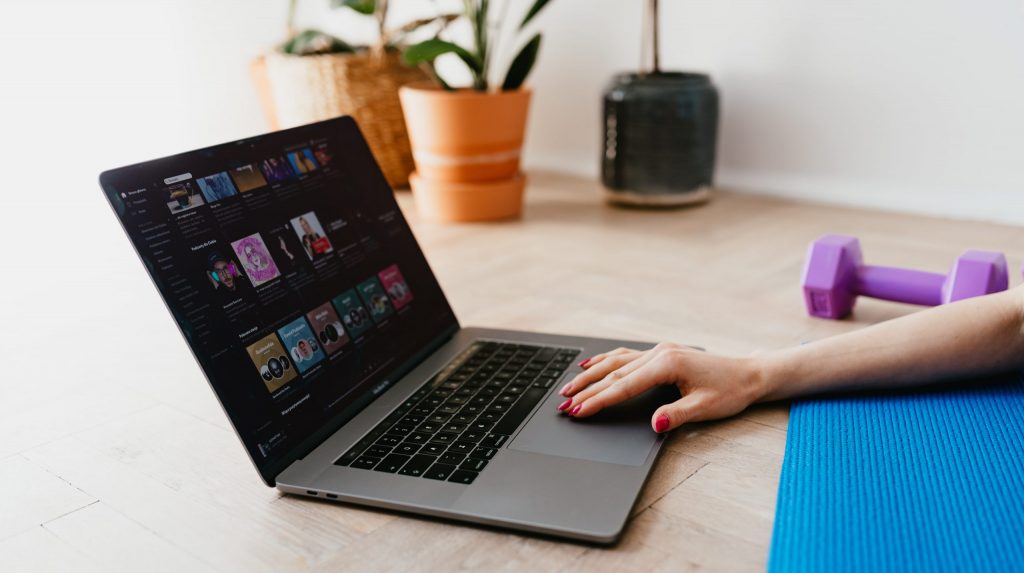 Faceless woman using laptop during sport exercising