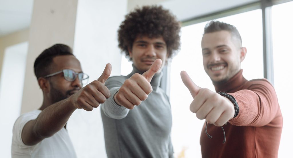 Men putting a thumbs up