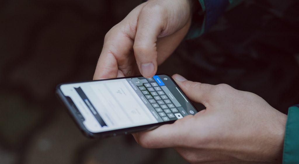 selective focus photography of person using smartphone