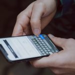 selective focus photography of person using smartphone