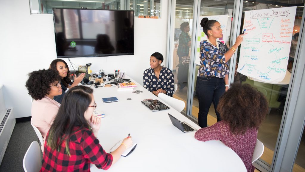 Women colleagues gathered inside conference room